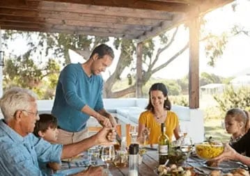 Family eating dinner together outdoors