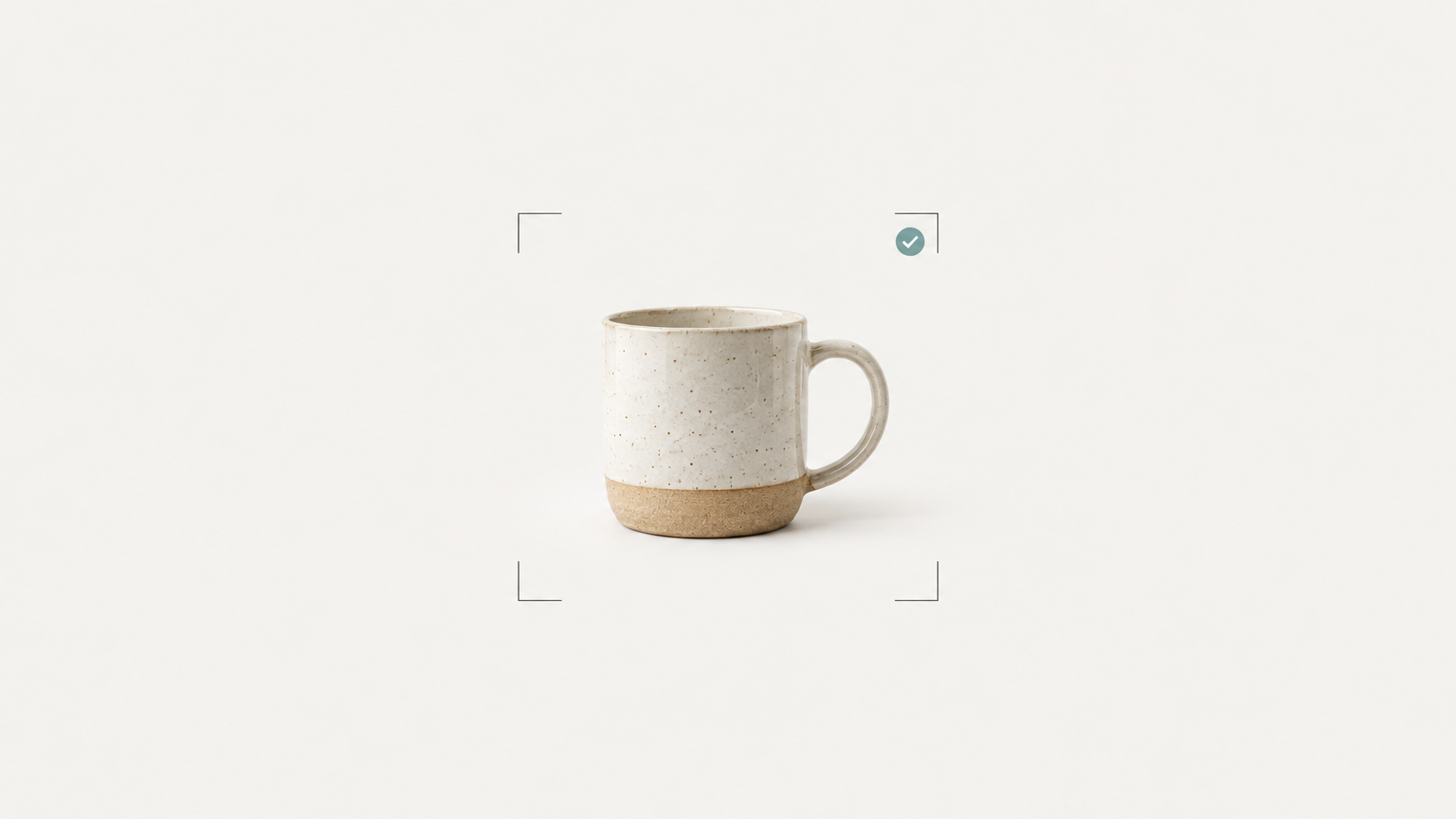 A ceramic mug framed by crop marks on a studio sweep