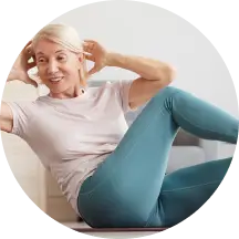 A person exercising indoors, performing side crunches on the floor.