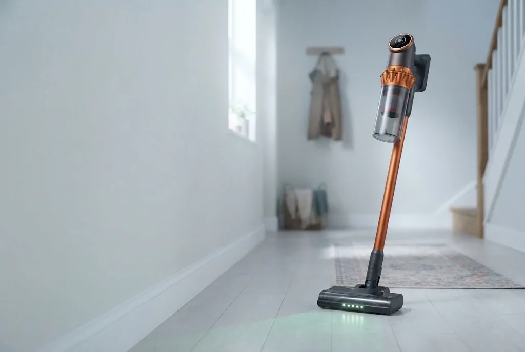 Vekto Vacuum V18 standing on its own in a bright hallway, its green lights on the floor ahead of it