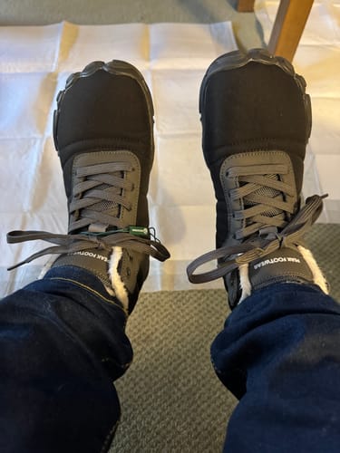 Customer's first-person view of the black and grey Zephyr Pro shoes, showing the fuzzy white lining at the ankle.