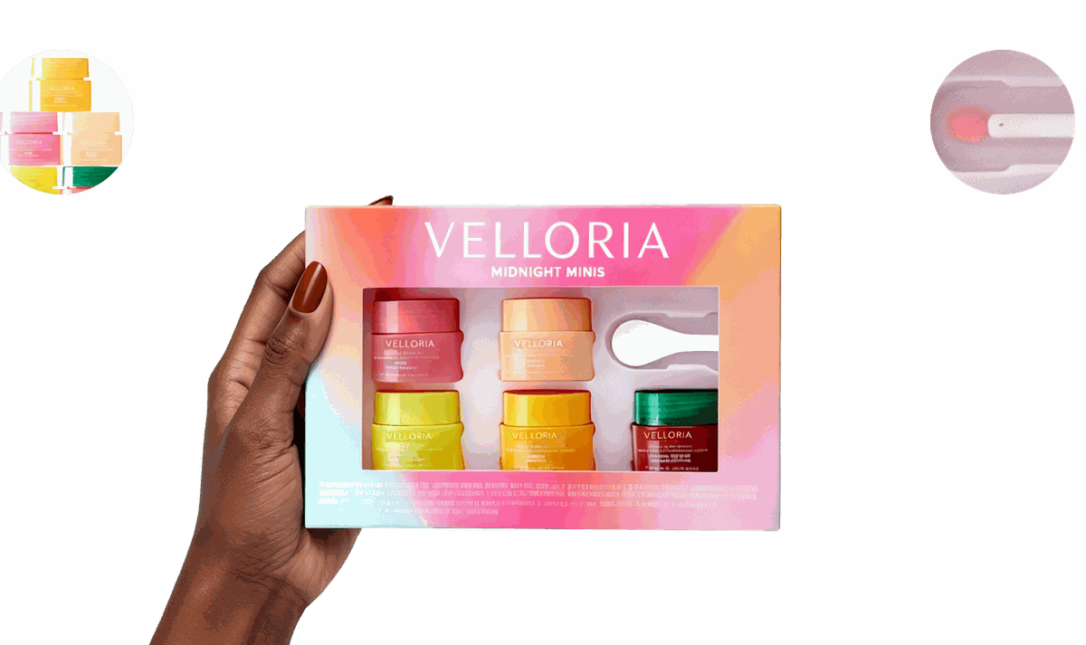A hand holding the Velloria Midnight Minis gift box
