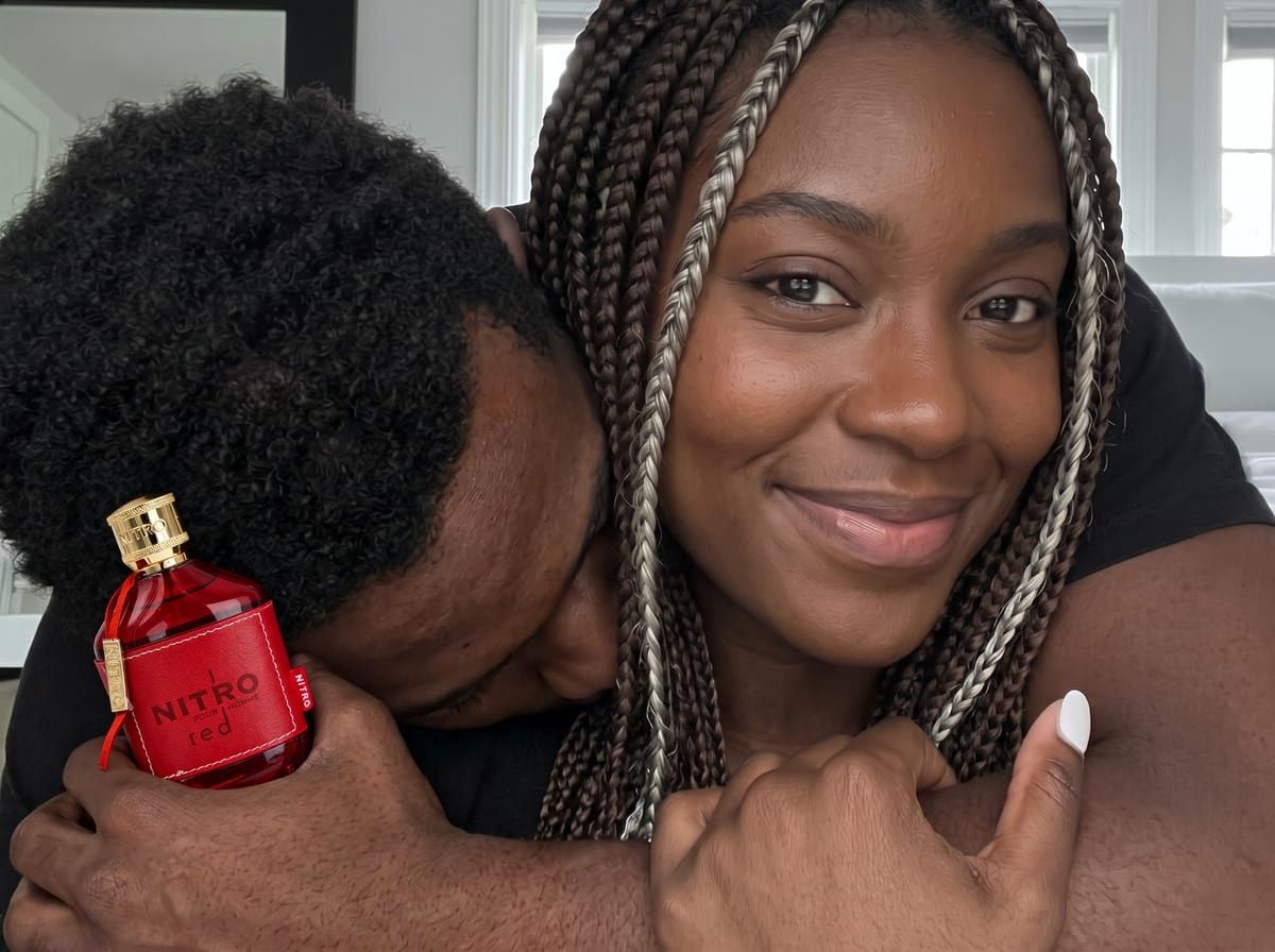 Couple hugging, he holds Dumont Paris Nitro Red