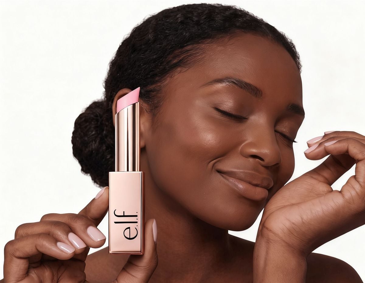 Woman holding the e.l.f. Glow Reviver Lip Oil Stick