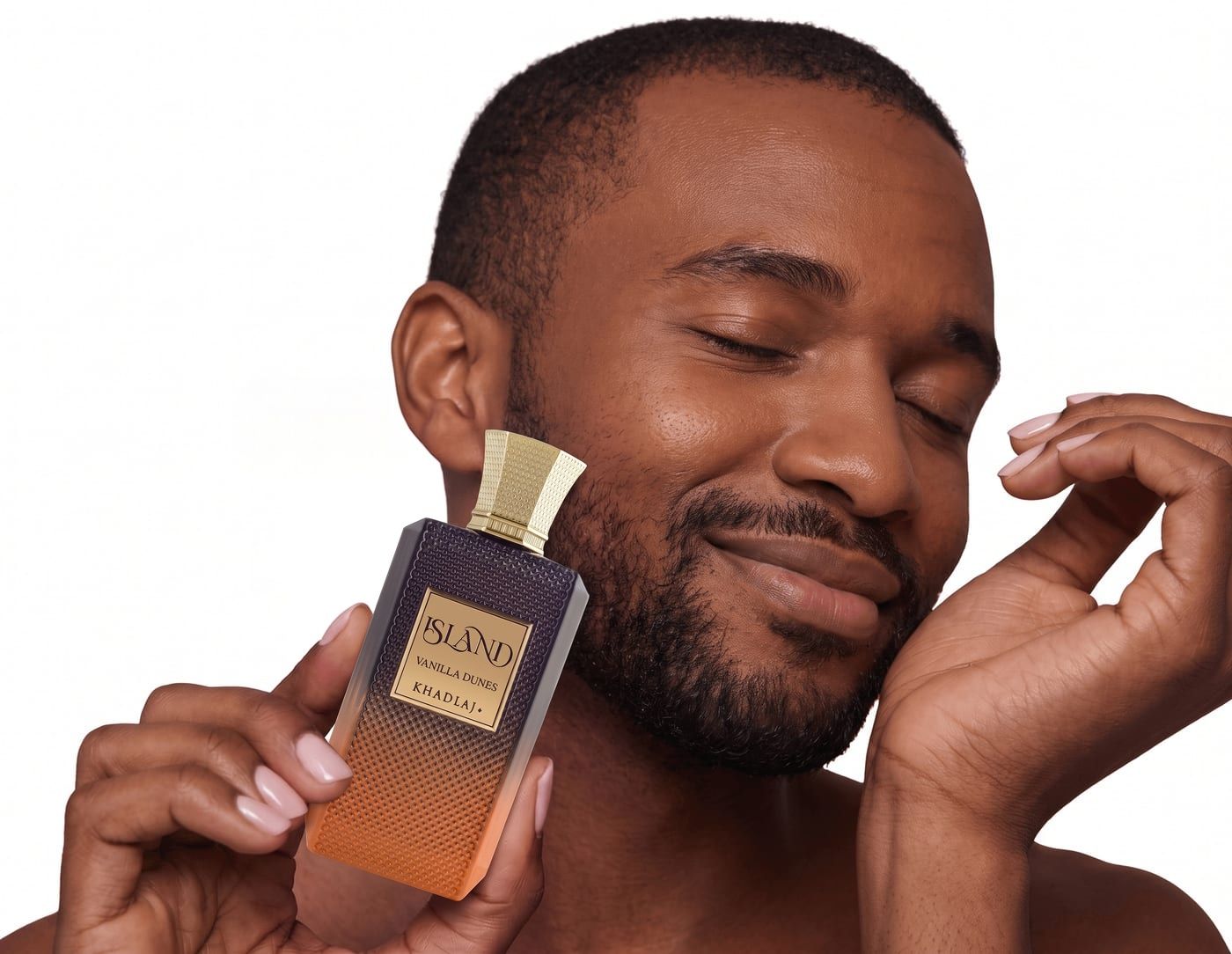 Man holding Khadlaj Island Vanilla Dunes against his cheek